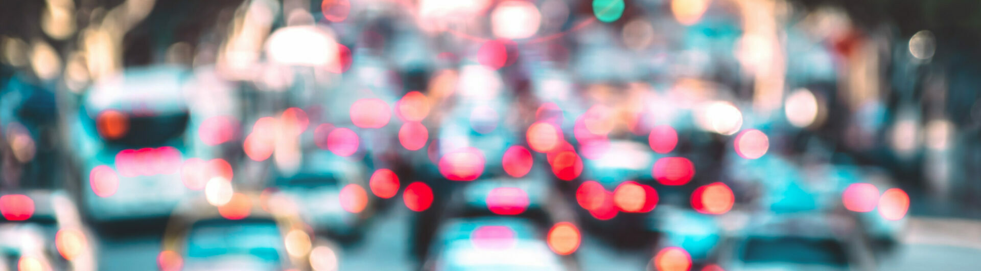 Blurred background of rush hour moment with defocused cars and generic vehicles - Traffic jam concept in Los Angeles downtown with bokeh of american iconic city with azure filtered headlights colors