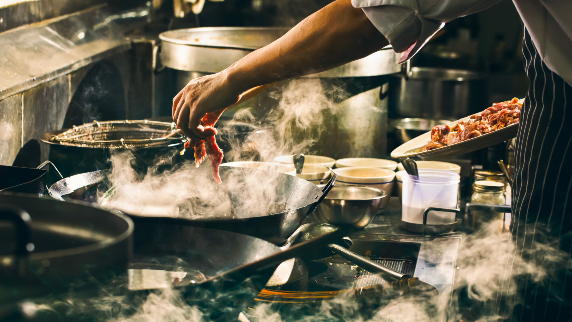 Chef is cooking beef in wok